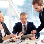 Group of confident business partners planning work at meeting